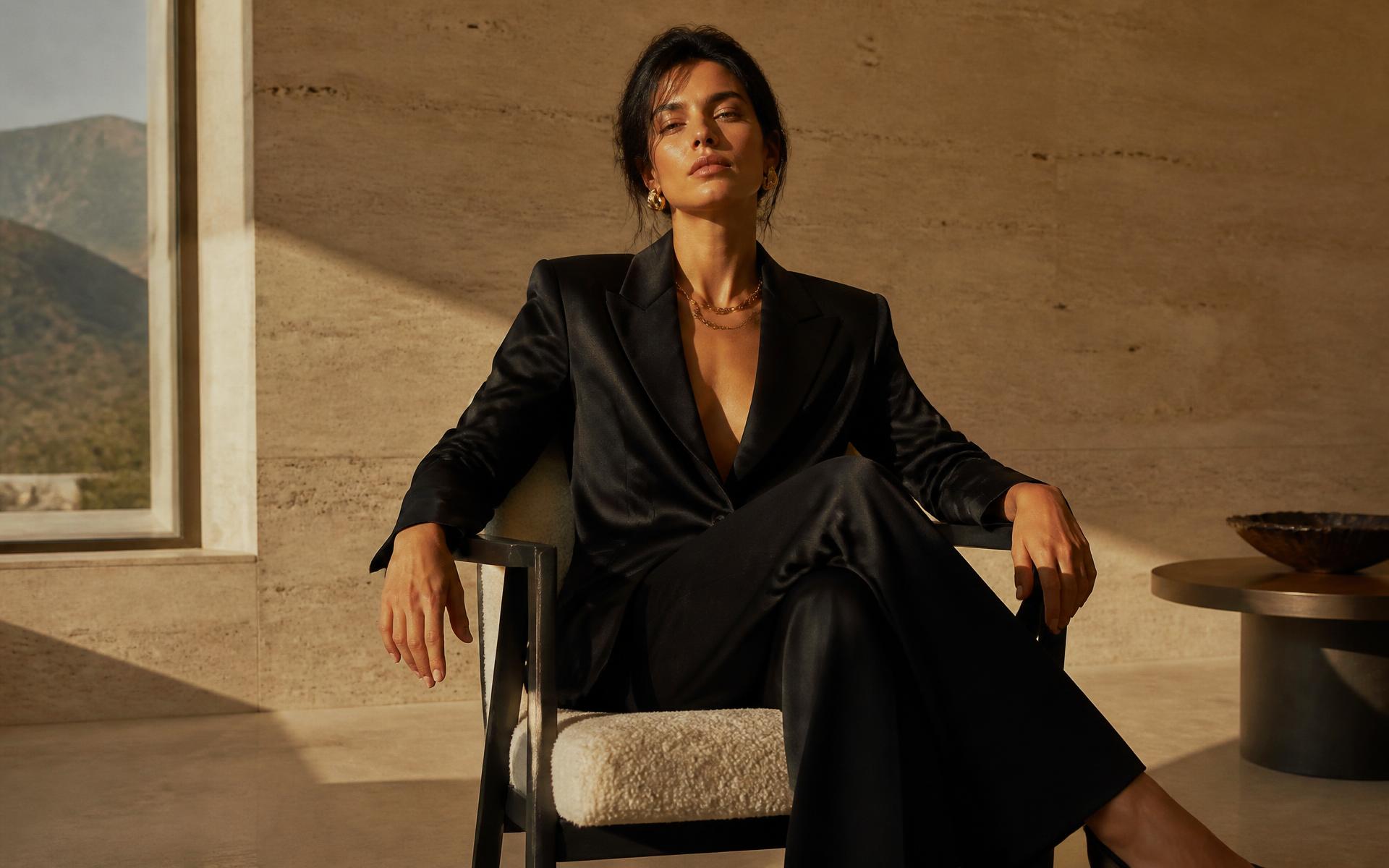 Model in a camel wool coat photographed in warm afternoon light